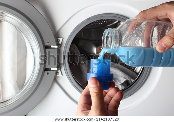 fabric softener\
washing machine pour\
hand