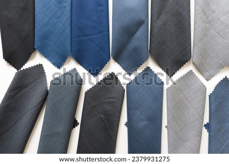 fabric swatches in various shades of blue and gray on white paper