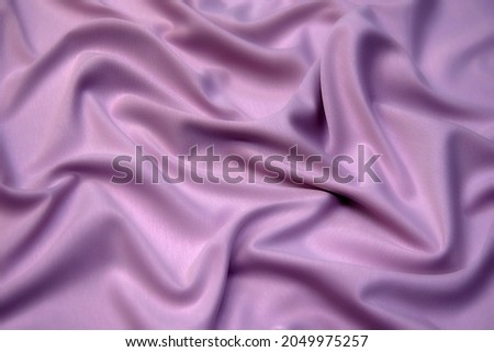 Fabric texture, background for design. Texture of puple silk or cotton or wool fabric. Beautiful pattern of waven fabric.