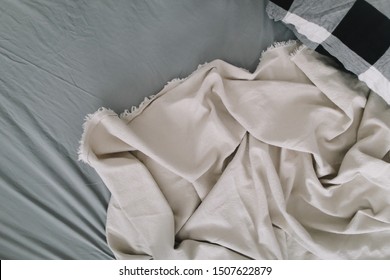 Fabric Texture Background. Wrinkled, Crumpled Fabric. Top View Of A Messy Bedding Sheet. Unmade Bed Sheet In The Bedroom After Night Sleep. Soft Focus
