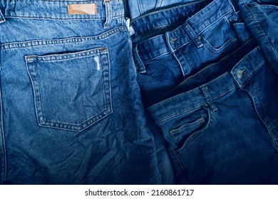 Fabric Texture, Close Up of Blue Denim Jean Texture with Back Pocket Detail..Destroyed torn classic denim blue jeans patches, banner fashion background