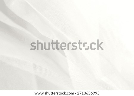 Fabric texture in cloud dancer shade of white, color year 2026. Organza tulle fabric texture background.Calm soft ethereal dreamy bridal wear fashion aesthetic.Blurry closeup drapery flowing folds bg
