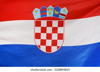 Fabric texture flag of Croatia. Flag of Croatia waving in the wind. Flag of Croatia is depicted on a sports cloth fabric with many folds. Sport team banner - Shutterstock ID 2228893819