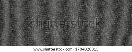 The fabric texture is fluted grey.The background of dense dark-gray patterned fabric.