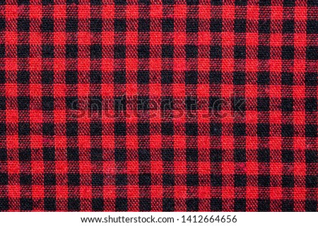 Fabric texture with grid pattern, red squares and black squares.