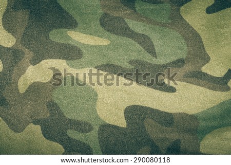 Fabrics with camouflage pattern. Background. Toned.