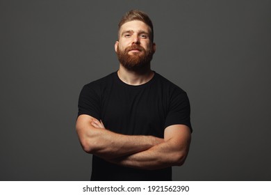 Fabulous at any age. Emotive portrait of laughing charismatic muscular 30-year-old man standing over light gray background. Perfect haircut. Rocker, biker, hipster style. Copy-space. Studio shot