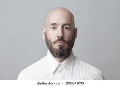 Fabulous At Any Age. Portrait Of 40-year-old Man Standing Over Light Gray Background In White Shirt. Close Up. Classic Style. Bald Shaved Head. Copy-space. Studio Shot