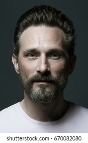 Fabulous At Any Age. Portrait Of 40-year-old Man Standing Over Dark Gray Background. Close Up. Classic Style. Scar On Forehead. Studio Shot