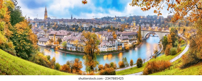 Fabulous autumn view of Bern city on  Aare river during evening with Pont de Nydegg bridge , cathedral of Bern and Nydeggkirche - Protestant church. Location: Bern, Canton of Bern, Switzerland, Europe