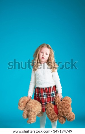 Fabulous little girl hugging brown teddy bear.