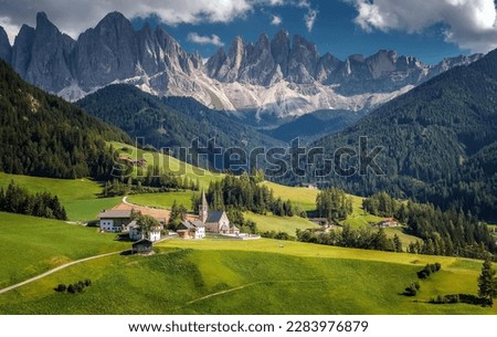 Fabulous nature in summer. Incredible landscape with mountain peaks, sprue forest and alpine meadow with fresh green grass. Amazing mountains landscape. Santa Maddalena. Dolomites. Italy.