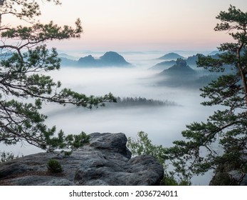 The fabulous vistas of Saxon Switzerland.  Kleiner Winterberg view, beautiful morning view over sandstone cliff into deep misty valley. - Shutterstock ID 2036724011