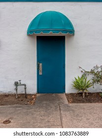 Facade Of Abandoned Building With Metal Door And Dome Style Awning