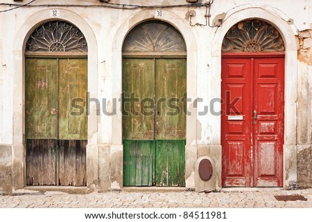 facade of abandoned building with three doors
