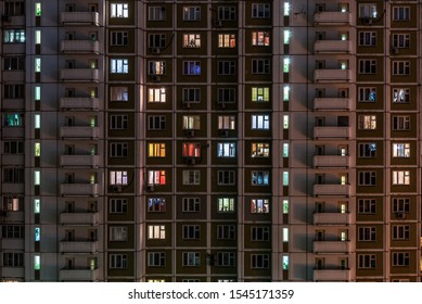 Facade Of An Apartment Building With Luminous Windows At Night