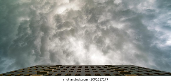 Facade of the apartment and a stormy sky