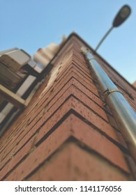 
facade from below with pipe and lamppost