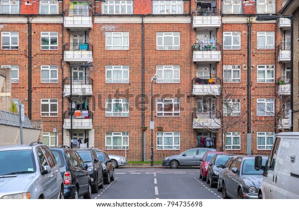 Facade of a block apartment at the end of street in\
London, UK