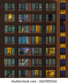 Facade Building At Night. Illuminated Windows Of The Hotel  Wall. Front View.