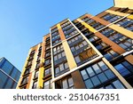 Facade building on blue sky. Modern building, houses. Colorful buildings with glass windows, balconies. Buildings architecture. Urban Residential building exterior. New Residential condominium.