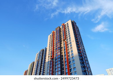 Facade building on blue sky background. Modern building, houses. Colorful buildings with glass windows, balconies. Buildings architecture. Skyline Skyscrapers. Urban Residential building exterior. - Powered by Shutterstock