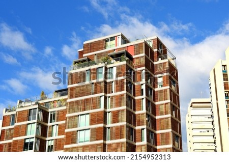Facade building. Residential building with balconies. Colorful buildings and hotel apartments. Facade of residential building in Spain. House with window and balcony. Buildings architecture.
