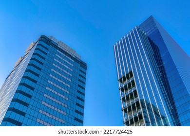 Facade Of Buildings With Glass Exterior Towering Against The Clear Blue Sky. Beautiful Skyline Of Austin Texas On A Sunny Day With Apartments And Modern Houses.