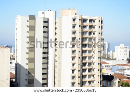Facade of buildings with windows and glass with the city in the background. Panoramic view