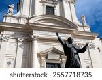 The facade of the Civitavecchia Cathedral, with a bronze statue of Pope John Paul II, Italy