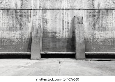 Facade of a concrete dam wall with support strut in monochrome. 