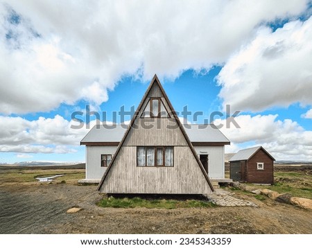 Facade exterior of triangular shaped scandinavian wooden house among wilderness in rural scene on summer at Iceland