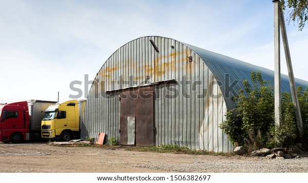 Facade of a\
gray metal warehouse, commercial building for storage of goods. The\
concept of storage of goods by importers, exporters, wholesalers,\
transport enterprises,\
customs