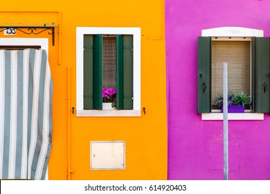 facade of the houses of Burano close-up, orange, pink