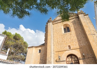Facade of the "Iglesia del Espiritu Santo" (meaning: Church of the Holy Spirit), Ronda, Andalusia, Spain. Blue sky with white clouds on the background.