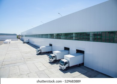 facade of an industrial building and warehouse with freight cars in length - Shutterstock ID 529683889