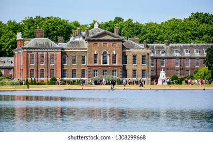 The Facade Of Kensington Palace, An Official Residence Of The British Royal Family, With The Round Pond In Kensington Gardens, London, England