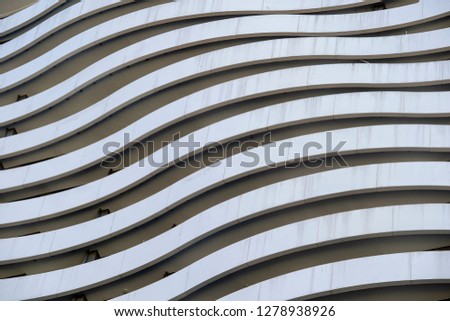 Facade of a modern apartment building. Lines patterns of facade with balcony of building view on exterior and architecture design concept