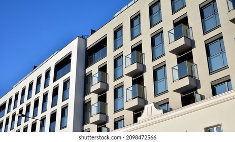 Facade of a modern apartment condominium in a sunny day. Modern condo buildings with huge windows and balconies. - Shutterstock ID 2098472566
