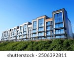 Facade of Modern complex of Apartment residential condo building. New Residential condominium building. Residential architecture exterior. Modern home, facade building. Condo Housing structure.