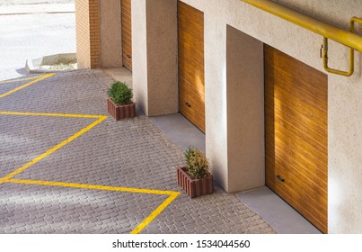 Facade Of A New Apartment Building With Car Garages On The First Floor. Selective Focus, View From Above. 