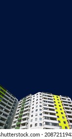 Facade Of New Multi-story Residential Building On Dark Blue Background. Renting Flat. Housing Development. Sale And Rental Apartments For Consumers. Windows And Balconies. House Sale Flyer. Copy Space