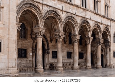 Facade of the old building of Dubrovnik with order arcade. Details of ancient architecture.