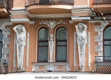 Facade of old building with statue 