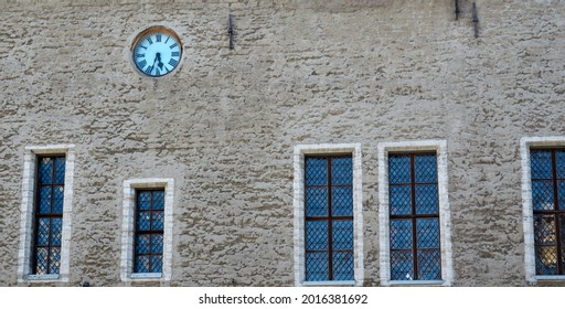 Facade of an old building with windows and an old clock. High quality photo