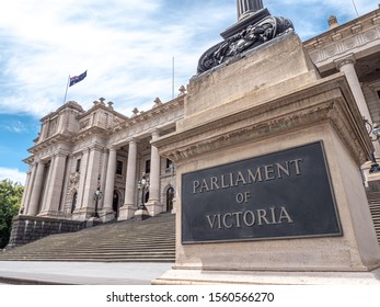 Facade Of The Parliament House Of The State Of Victoria In Melbourne, Australia. Stairways And A Flag Of Australia, Blue Sky During A Day Of Spring.