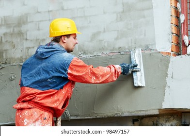 Facade Plasterer At Outdoor Wall Renovation Decoration With Float