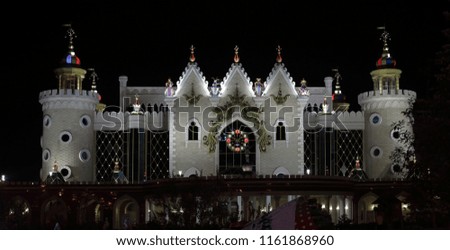facade of a puppet theater with a clock on the background of a black sky