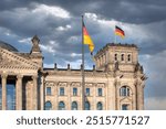 Facade Reichstag building Berlin with german flag and threatening air