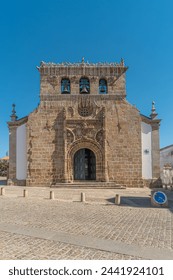 Facade of the sixteenth century Gothic Manueline church with a three bells belfry, in the town of Vila Nova de Foz Coa, Portugal